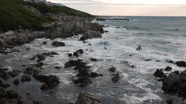 stormy sea meeting rocky coastline of DeKelders, South Africa