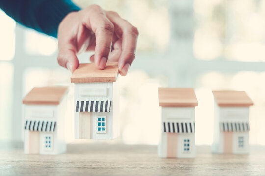Hand chooses wooden franchise business store for franchising to growth branch expansion and business banking loan or consumer resources service.