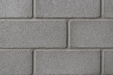 Fototapeta premium Close up of a gray concrete cinder block wall with textured surface and mortar lines