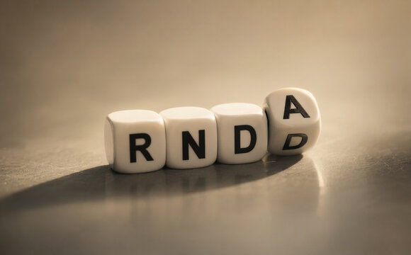 AI generated close up of lettered dice forming RND with soft light and shallow depth symbolizing research development innovation strategy and modern business thinking