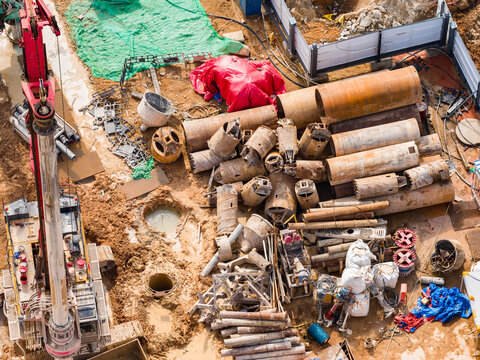 earthmoving with bore pile rig machine used this during drilling soil for the foundation work at construction site, aerial view.