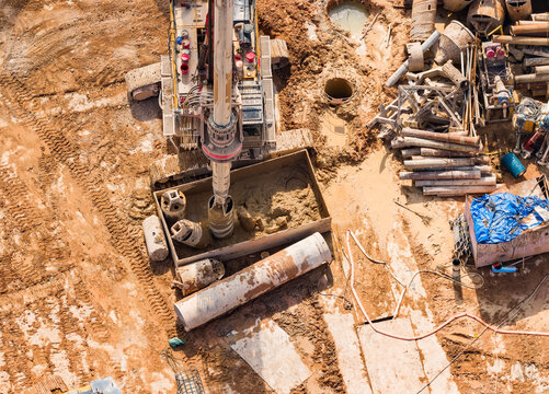 earthmoving with bore pile rig machine used this during drilling soil for the foundation work at construction site, aerial view.