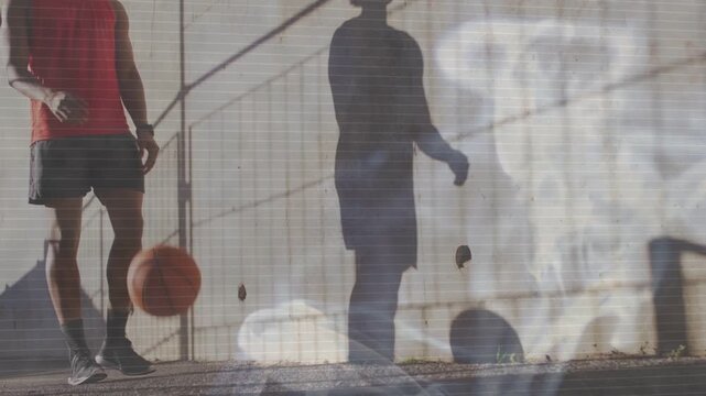 Man entering left, walking and dribbling basketball, wall shadow shifting with light-leak, training