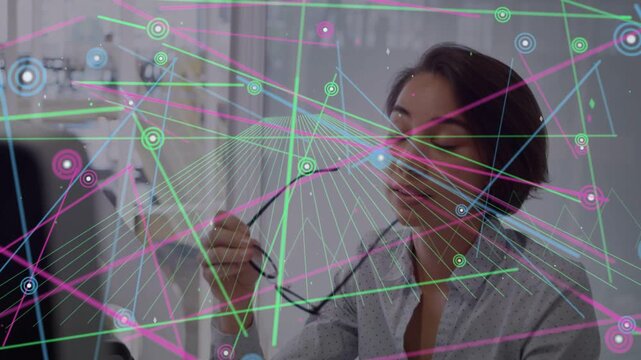 Tech worker inspecting glasses, animated overlay crossing face, donning glasses, refocusing monitor