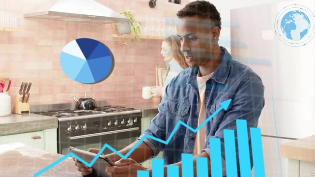 Man tapping tablet causing charts over island, woman handing mug, both analyzing finance data