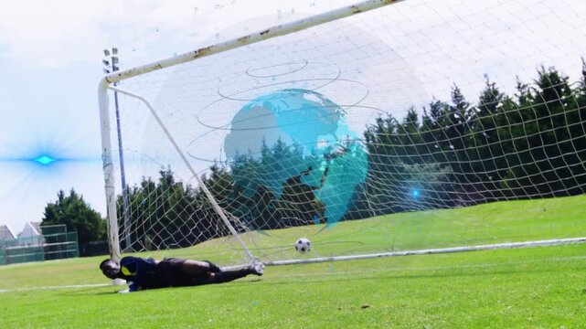 Soccer left-shot after GK attempting diving deflecting ball in net with holo-globe moving over goal