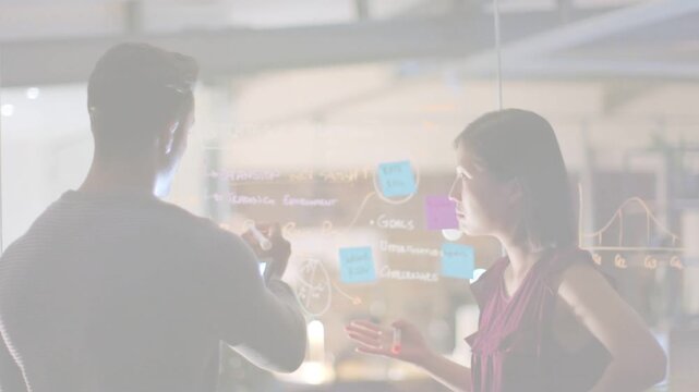 Man showing tablet to woman, pointing and writing on glass for design, animated highlights on notes