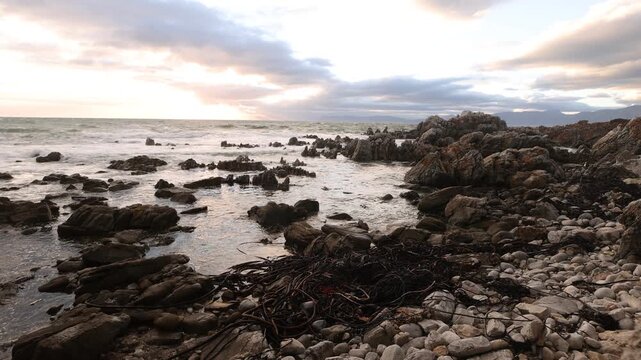 stormy sea meeting rocky coastline of DeKelders, South Africa