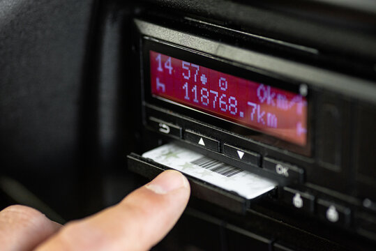 Hand inserting driver card into digital tachograph
