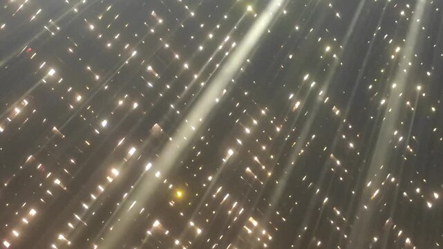 Sunlight rays entering a dark room with floating smoke visible particles