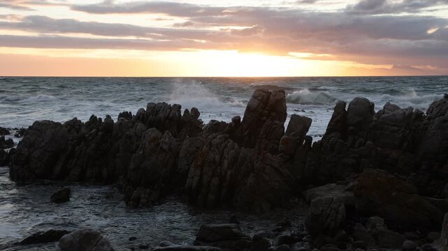 stormy sea meeting rocky coastline of DeKelders, South Africa
