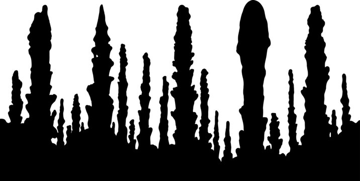 Limestone stalagmites silhouette standing in an underground cavern environment