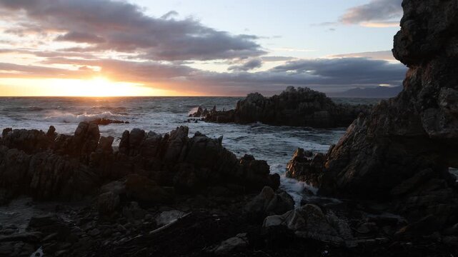 stormy sea meeting rocky coastline of DeKelders, South Africa