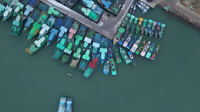 Aerial View Of Fishing Boats Docked At Harbor