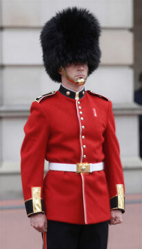 Royal guard soldier in red uniform standing at attention