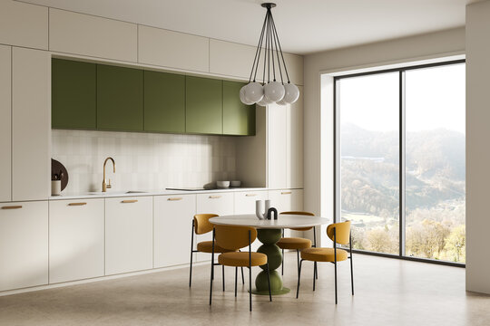 Modern minimalist kitchen interior with green cabinets, round dining table, mustard chairs, expansive window view and warm natural lighting. 3D Rendering