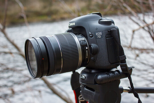 Wylam UK: 13th April 2013: A Canon 7d camera is set on a tripod in a natural area. Branches and plants surround the camera. The scene takes place during the day with clear light