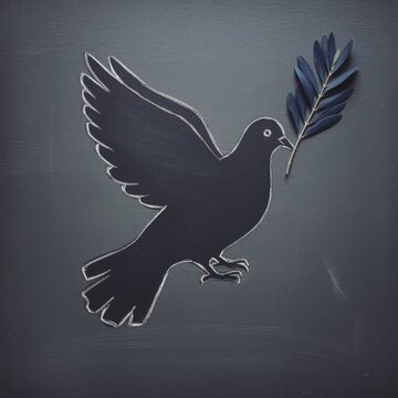Dark chalk dove silhouette with olive branch on grey textured surface for peace symbols, educational posters and inspirational storytelling imagery