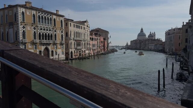 Tranquil view of Venice Grand Canal from wooden bridge