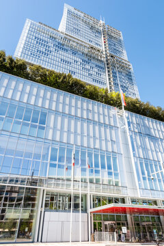 Paris, France - April 7, 2026: Low angle view of the "Tribunal de Paris" (Courthouse of Paris), a 38 storeys, 160 metres high building by architect Renzo Piano, seen from the Parvis Robert Badinter.