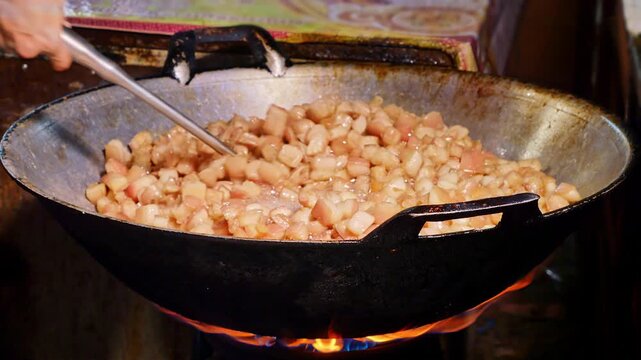Fresh pork skin pieces frying in bubbling oil, capturing the essence of homemade crispy pork rind snack.
