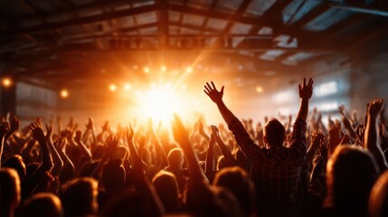 Fototapeta premium A dynamic image of an energized crowd joyfully cheering at a live musical performance, encapsulating the spirit of celebration and shared experiences in vibrant lighting.