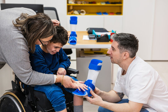 Parents helping child with leg brace fitting