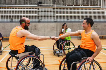 Obraz premium Wheelchair basketball players celebrating a fist bump victory