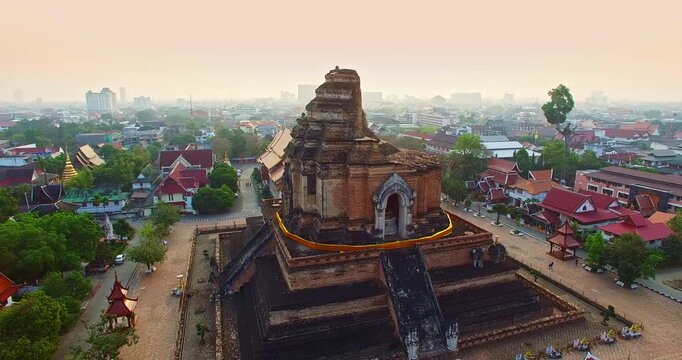 A scenic aerial of Wat Chedi Luang Varavihara, featuring the Great Stupa and historic ruins in the heart of Chiang Mai. The temple intricate architecture and religious symbolism reflect centuries