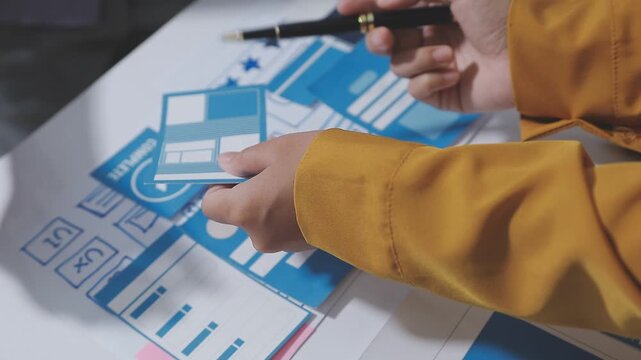UXUI design collaboration with devices and sketches on table