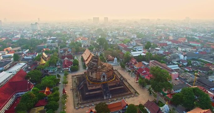 A scenic aerial of Wat Chedi Luang Varavihara, featuring the Great Stupa and historic ruins in the heart of Chiang Mai. The temple intricate architecture and religious symbolism reflect centuries