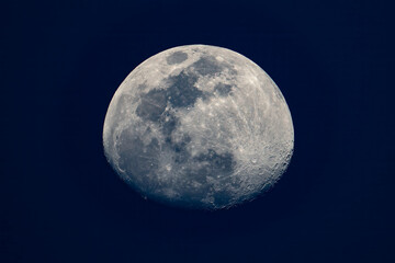 Detailed waxing gibbous moon with visible craters against dark blue sky © sorao.211(T.SAWADA)