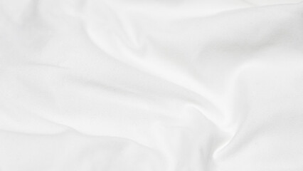 Fototapeta premium shot of a white fabric surface with a gentle horizontal fold and soft ripples