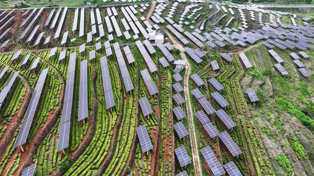 Aerial view of a terraced photovoltaic power station integrated with agricultural landscape