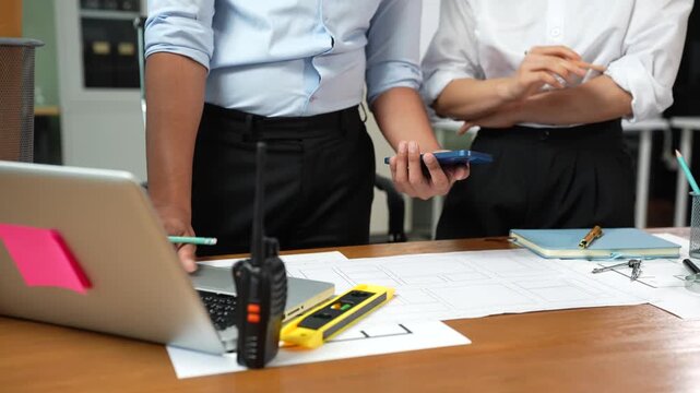 Close up of Engineer teams hands making model house. Engineer teams working in the office.
