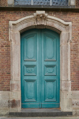 Fototapeta premium Teal door charms brick building