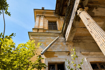 Lush greenery and decayed structures beneath bright blue sky © diczman