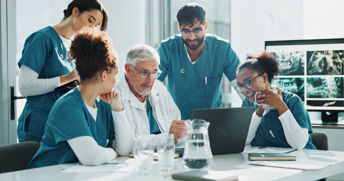 Doctor, nurses and meeting in hospital with laptop, discussion and medical research for diagnosis. Healthcare team, people and talk in clinic with computer, advice or planning together for surgery.