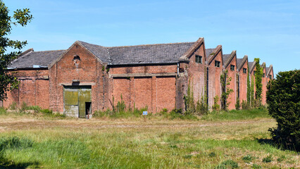 Obraz premium Rural Decline And Industrial Decay Old Tram Depot Building (tram remise Maldegem-Breskens) In Draaibrug Zeeland Netherlands Showing Economic Decline And Abandonment In A Rural Landscape