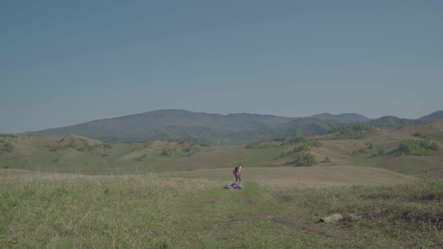 Skydiver after landing in wilderness area. Extreme sports, adrenaline, risk, challenges.
