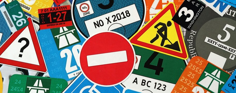 Pattern of traffic and road signs including warning symbols, Swiss and German vignettes