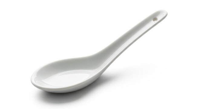 A single white ceramic spoon resting on a white background kitchen utensil