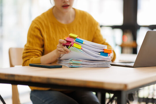 Person compiling and organizing a stack of documents