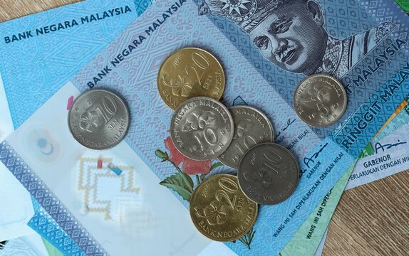 Malaysian ringgit money bills and coins on table. Malaysia cash of MYR currency close up