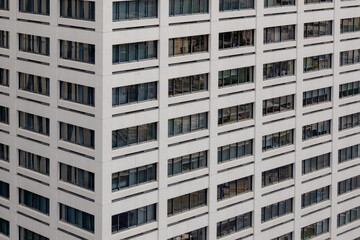 Fototapeta premium Office building facade with repeating window grid pattern