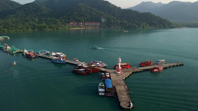 Aerial view of Bang Bao fishing village and pier, Ko Chang island, Thailand. Traditional coastal community with mountai