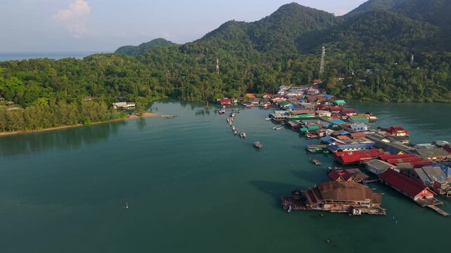 Aerial view of Bang Bao fishing village and pier, Ko Chang island, Thailand. Traditional coastal community with mountai