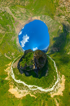 Aerial view of Rocky Mountains with river and waterfall, hyperbolic projection.