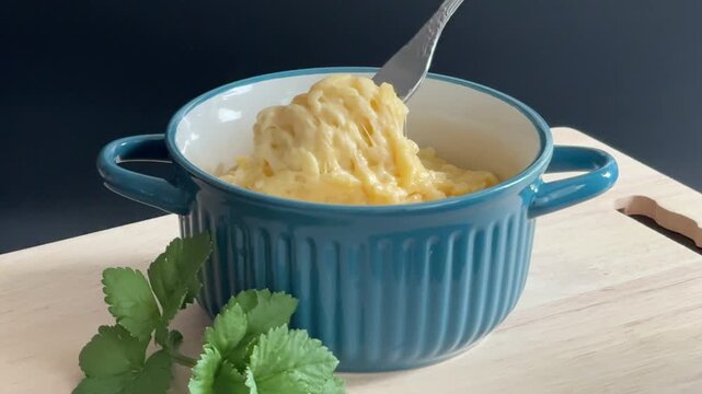 Close-up of Fork Lifting Mac and Cheese with Melting Cheese Stretches