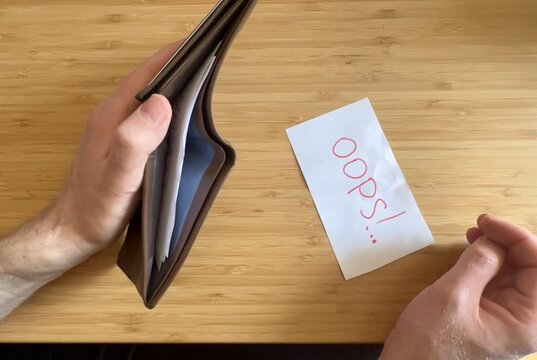 hands opening an empty wallet due to inflation and high prices